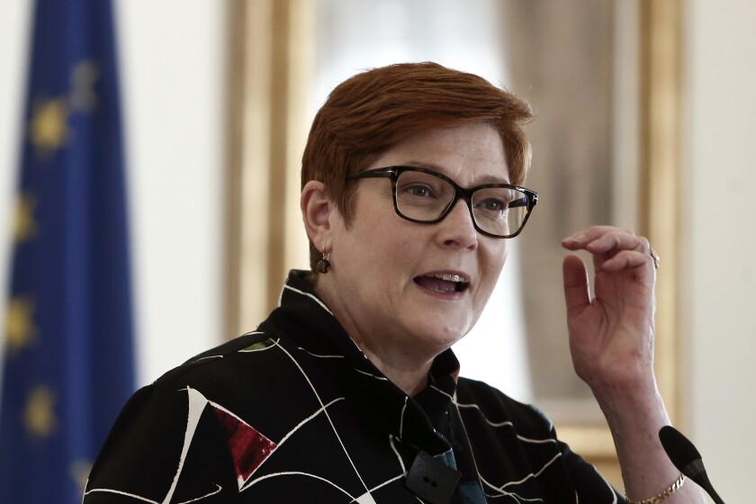Australian Foreign Minister Marise Payne makes statements after a meeting with her Greek counterpart Nikos Dendias, right, in Athens, Greece, Wednesday, Dec. 8, 2021. The foreign minister of Australia, launching a European tour in Athens Wednesday, welcomed a recent initiative by the European Union to boost its presence in the Indo-Pacific region despite a spat with EU member France over the cancelation of a massive submarine order. (Panayotis Tzamaros/InTime News via AP)