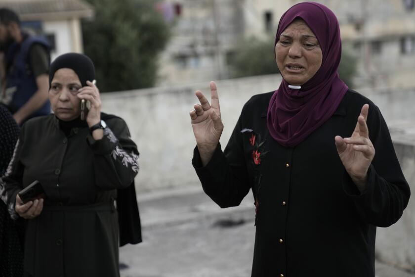 A distraught Palestinian woman reacts at the site where Israeli forces killed her nephew, a militant who was killed along with a civilian in a raid in the Balata refugee camp in the West Bank city of Nablus, Monday, June 3, 2024. Palestinian authorities said two men were shot dead by Israeli forces during a raid in the occupied West Bank on Monday. According to Israeli police, the raid took place in the northern city of Nablus. (AP Photo/Majdi Mohammed)