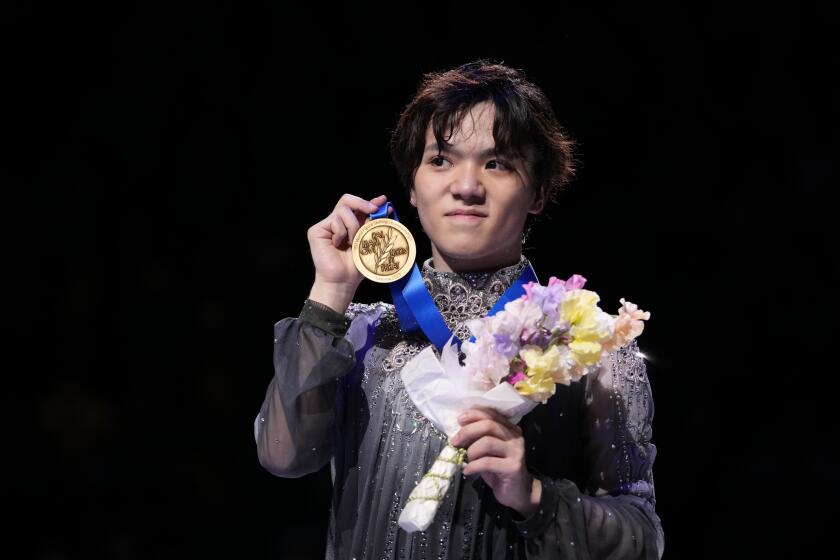 FILE - Shoma Uno of Japan shows off his gold medal after winning the men's free skating in the World Figure Skating Championships in Saitama, north of Tokyo, on March 25, 2023. Olympic medalist and two-time world champion Uno said Thursday, May 9, 2024, he is retiring. (AP Photo/Hiro Komae, File)