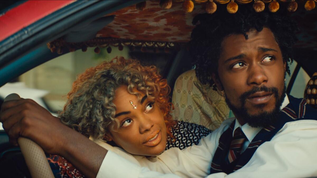 Tessa Thompson, left, and Lakeith Stanfield star in "Sorry to Bother You."