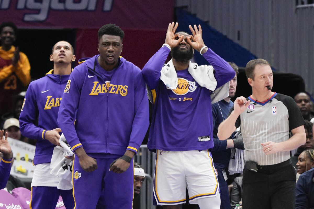 Lakers center Thomas Bryant and forward LeBron James react after their team scores against the Wizards 