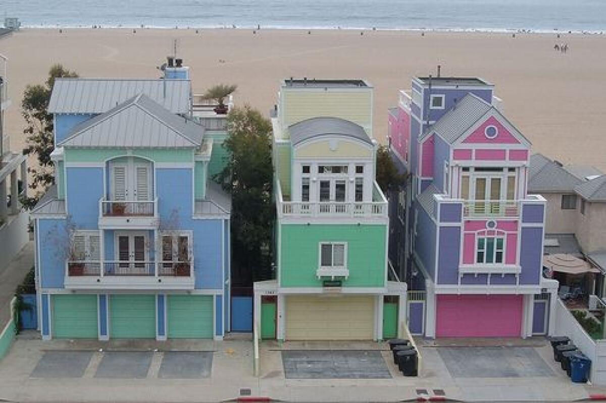 The pastel homes were all painted by a developer in the 1990s, but only the pink-and-purple home still looks the same.