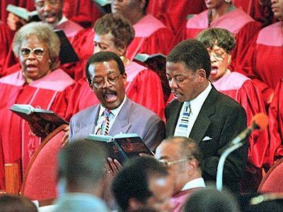 Johnnie L. Cochran Jr., left, and Carl Douglas, defense attorneys for O.J. Simpson, sing along with the Brookins AME Church choir in Los Angeles after being honored by the church as "Lawyers of the Year" in 1996.