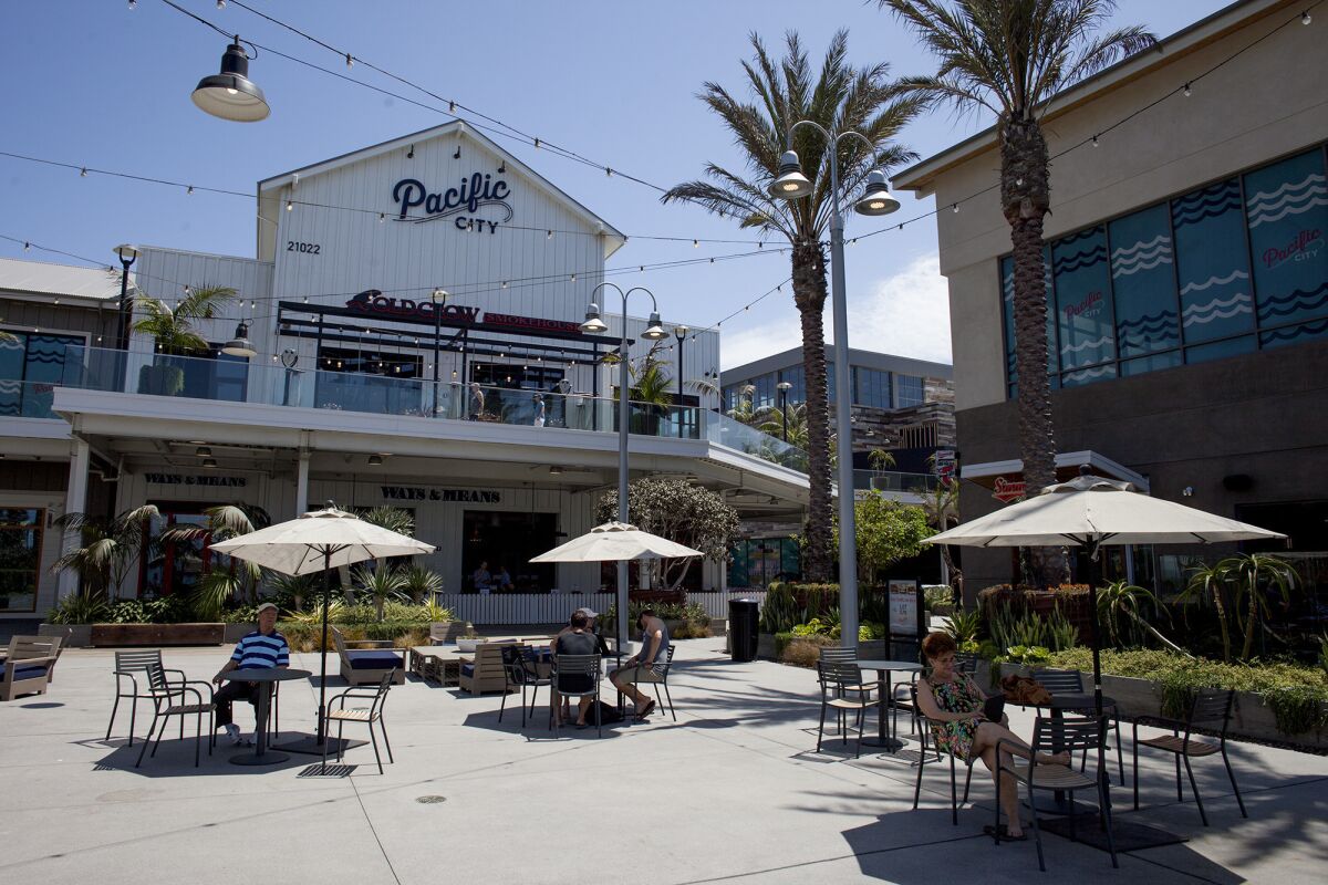 Diners sit outdoors at Pacific City restaurants in Huntington Beach in 2016. 