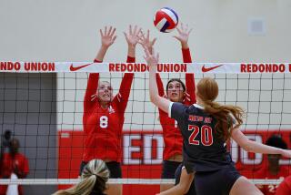 Avery Junk (left) and Sienna Castillo block a tip attempt by Mater Dei's Addison Coady in the Sea Hawks' victory.