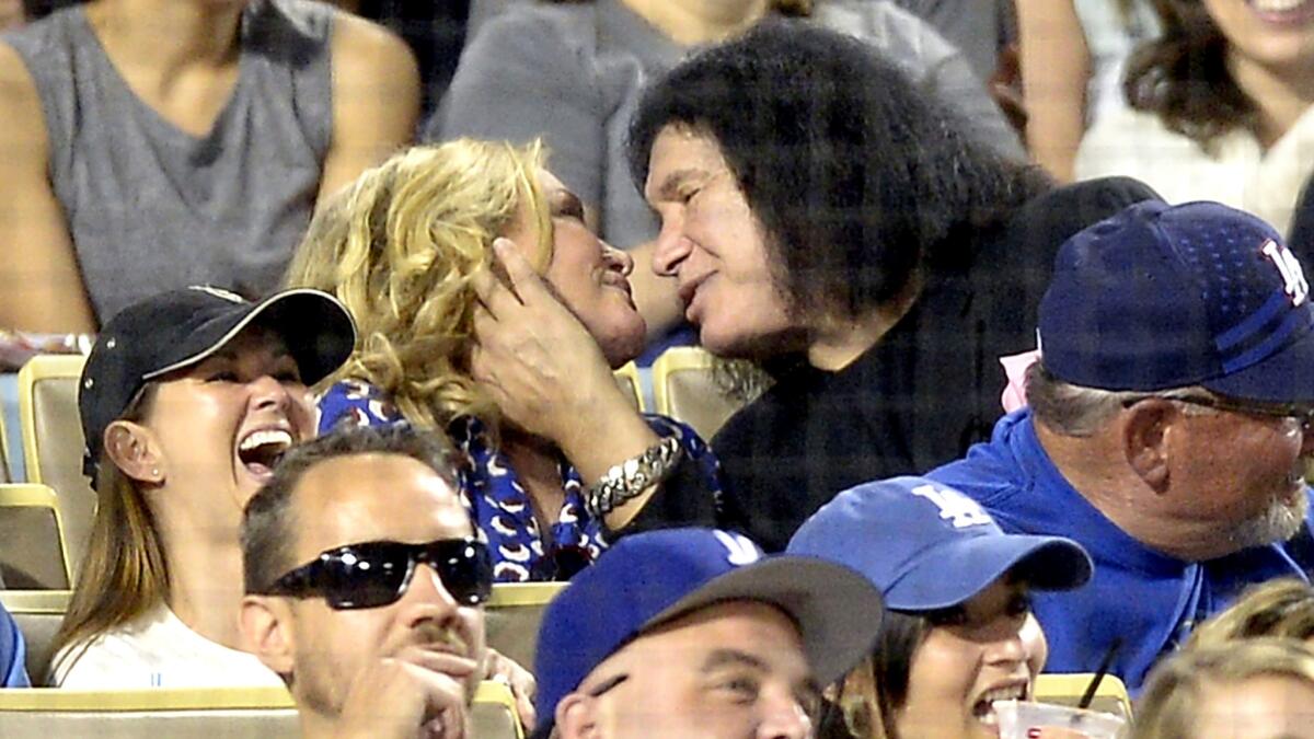 Gene Simmons leans in to give wife Shannon Tweed a smooth while appearing on the "Kiss Cam" at Dodger Stadium last summer.