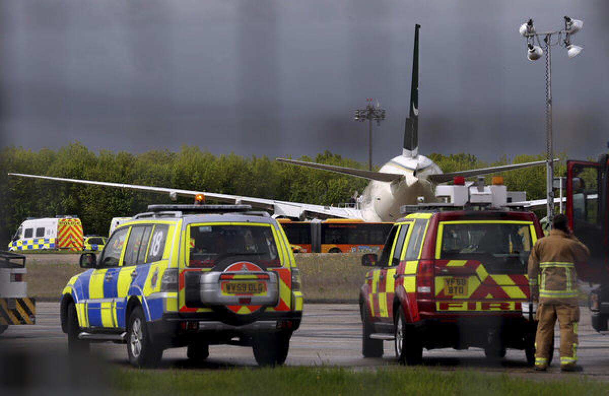 Police and rescue vehicles wait at Stansted Airport on the outskirts of London after a Pakistan International Airlines flight bound for Manchester, England, from Lahore, Pakistan, was diverted.