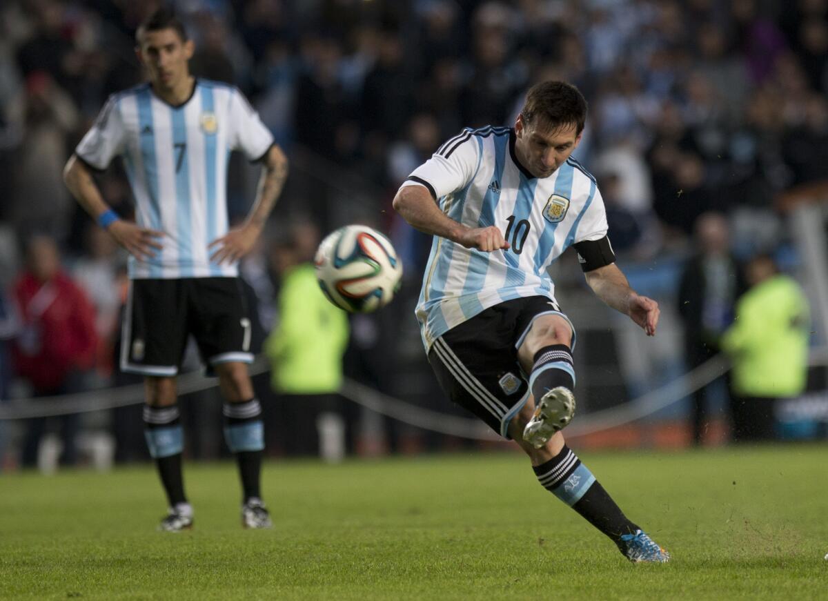 Argentina's Lionel Messi kicks the ball during an international friendly soccer match with Slovenia.