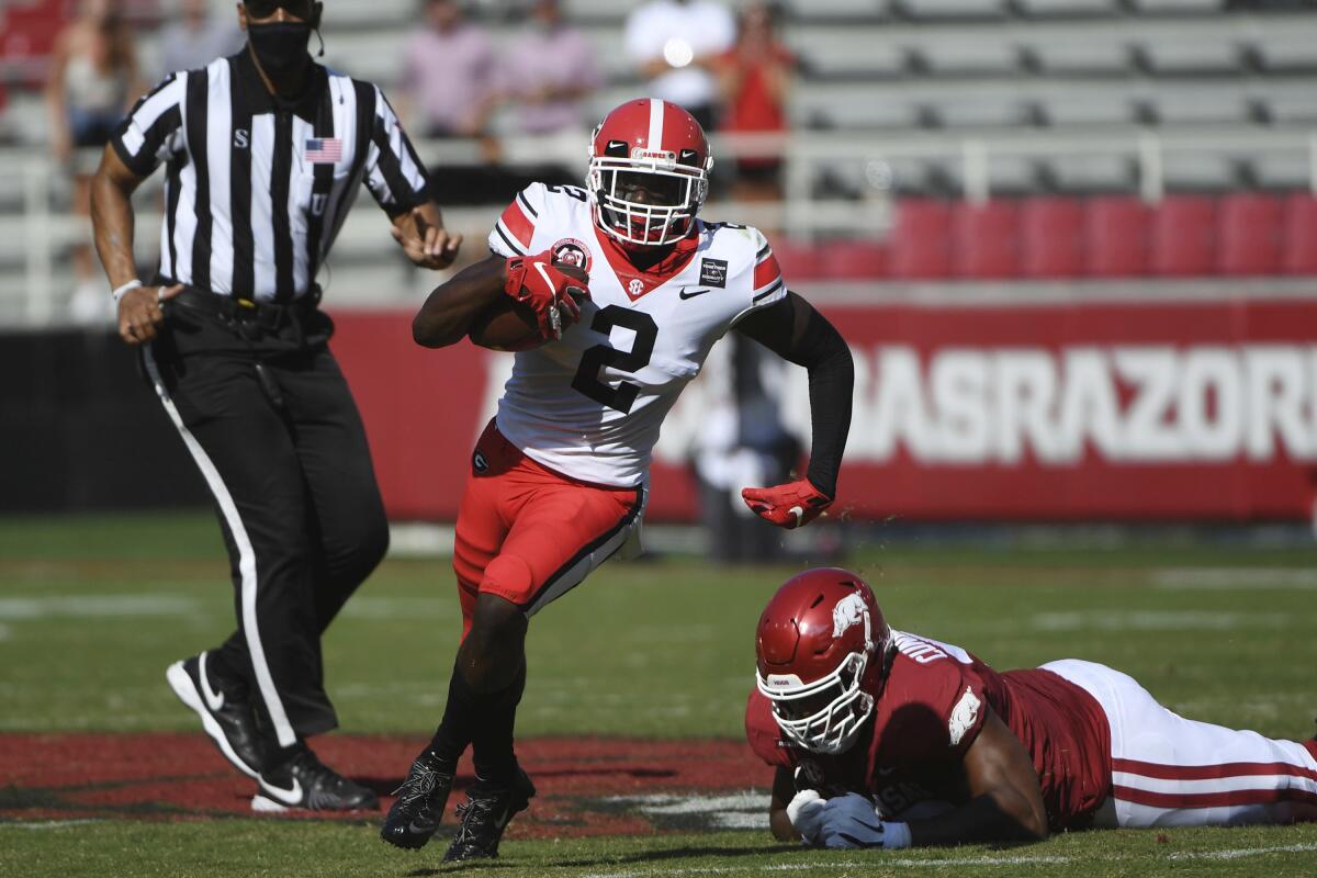 Georgia defensive back Richard LeCounte (2) returns an interception against Arkansas during the first half of an NCAA college football game in Fayetteville, Ark., Saturday, Sept. 26, 2020. Just in time for a key SEC East game against No. 8 Florida, No. 5 Georgia has to adjust to a rash of new injuries on defense after a rough weekend capped by safety Richard LeCounte avoiding life-threatening injuries in an accident while riding his motorcycle. (AP Photo/Michael Woods, File)