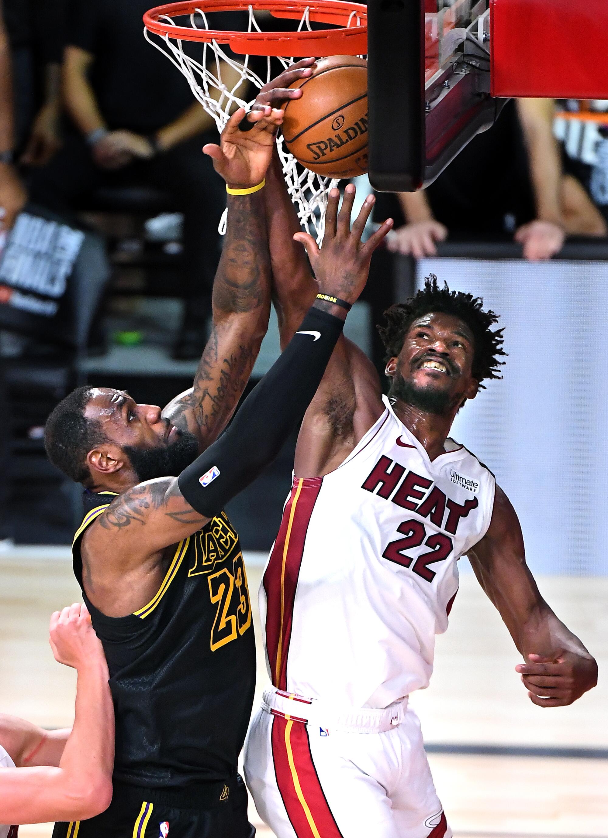Lakers forward LeBron James battles for a rebound against Miami's Jimmy Butler in Game 2 of the NBA Finals.