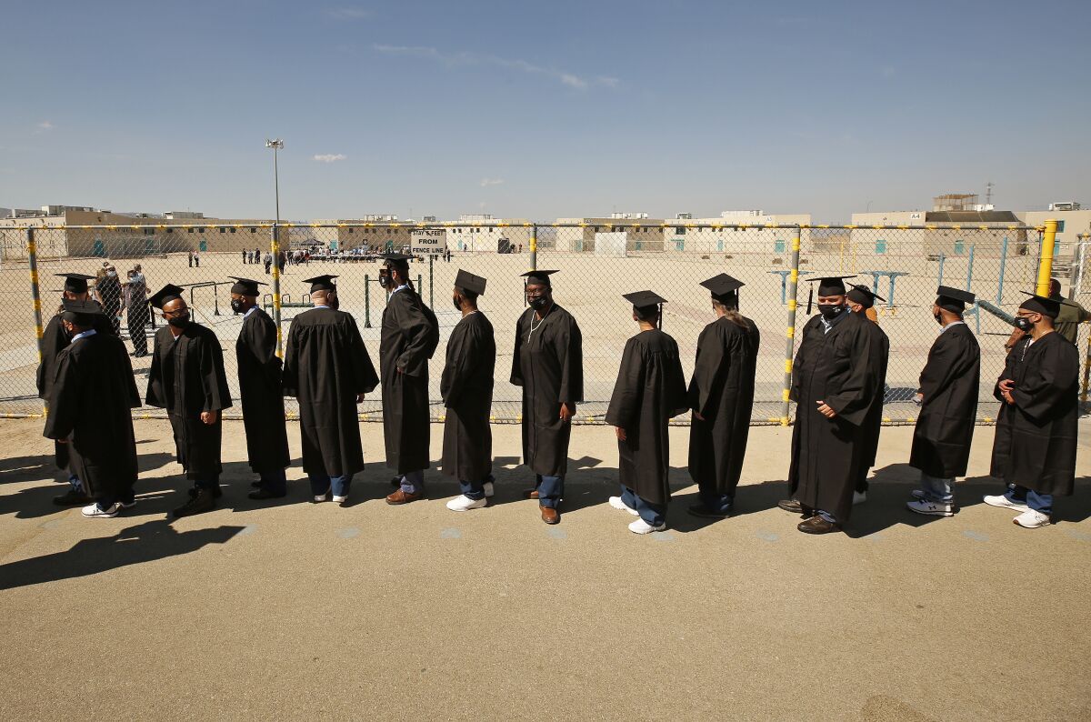 New graduates of Cal State L.A.'s Prison B.A. Program enter the yard at California State Prison in Lancaster