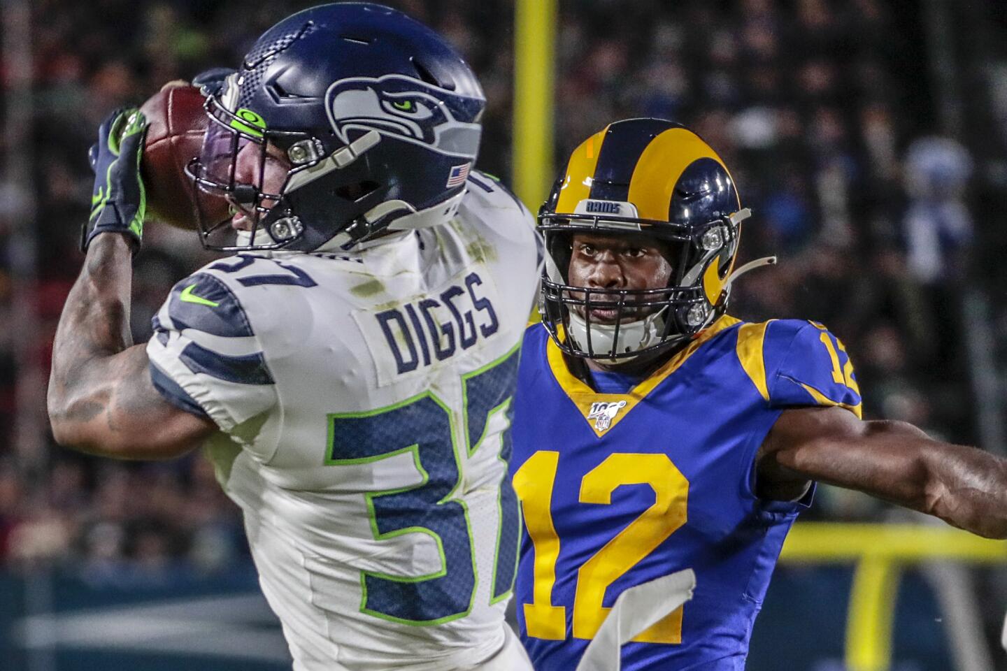Seattle Seahawks cornerback Quandre Diggs intercepts a pass intended for Rams wide receiver Brandin Cooks.