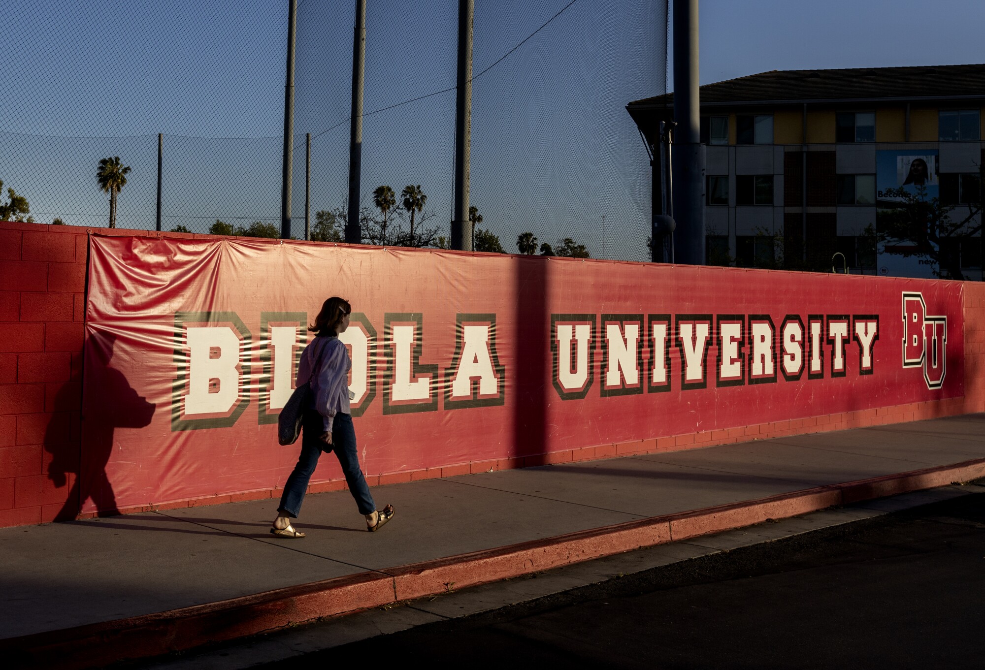 A person walks on campus.