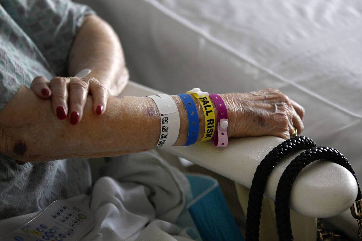 Claire Gordon, 96, wears a variety of medical bracelets during her stay at Cedars-Sinai Medical Center in Los Angeles, including a yellow one that lets the staff know she's at risk of falling.