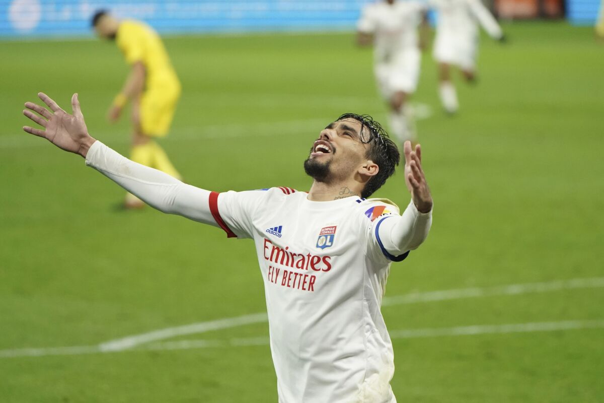 FILE - In this Wednesday, Dec. 23, 2020 file photo, Lyon's Lucas Paqueta celebrates after scoring his sides's third goal during the French League One soccer match between Lyon and Nantes, in Decines, near Lyon, central France. When the best player in Lyon's history phoned AC Milan's greatest defender they talked business. Juninho persuaded Paolo Maldini, Milan's technical director and his former Champions League adversary to sell midfielder Lucas Paqueta to Lyon for 20 million euros ($24.5 million). It has proved the signing of the French season, with Paqueta the driving force in a Lyon side three points clear at the top and heading into Saturday's trip to Rennes unbeaten in 15 games. (AP Photo/Laurent Cipriani, File)