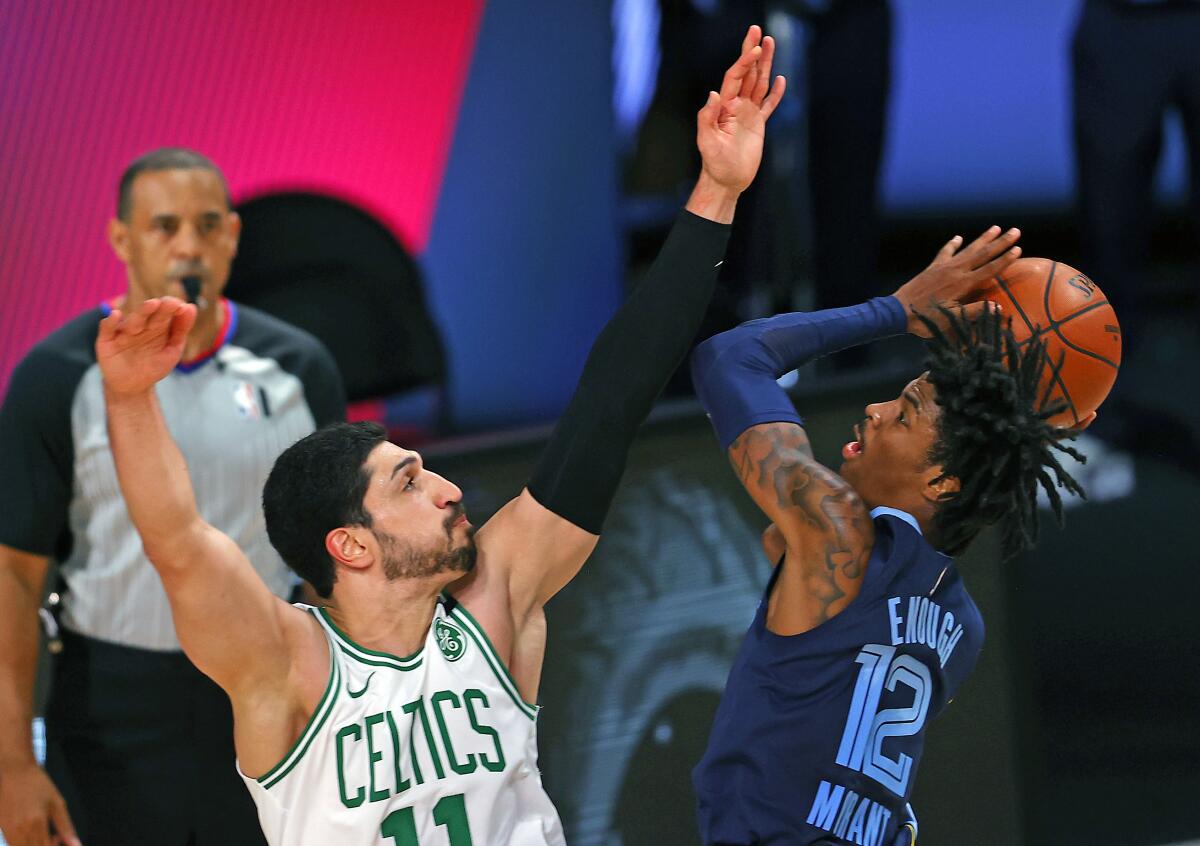 Boston Celtics' Enes Kanter defends against Memphis Grizzlies' Ja Morant on Tuesday in Lake Buena Vista, Fla.