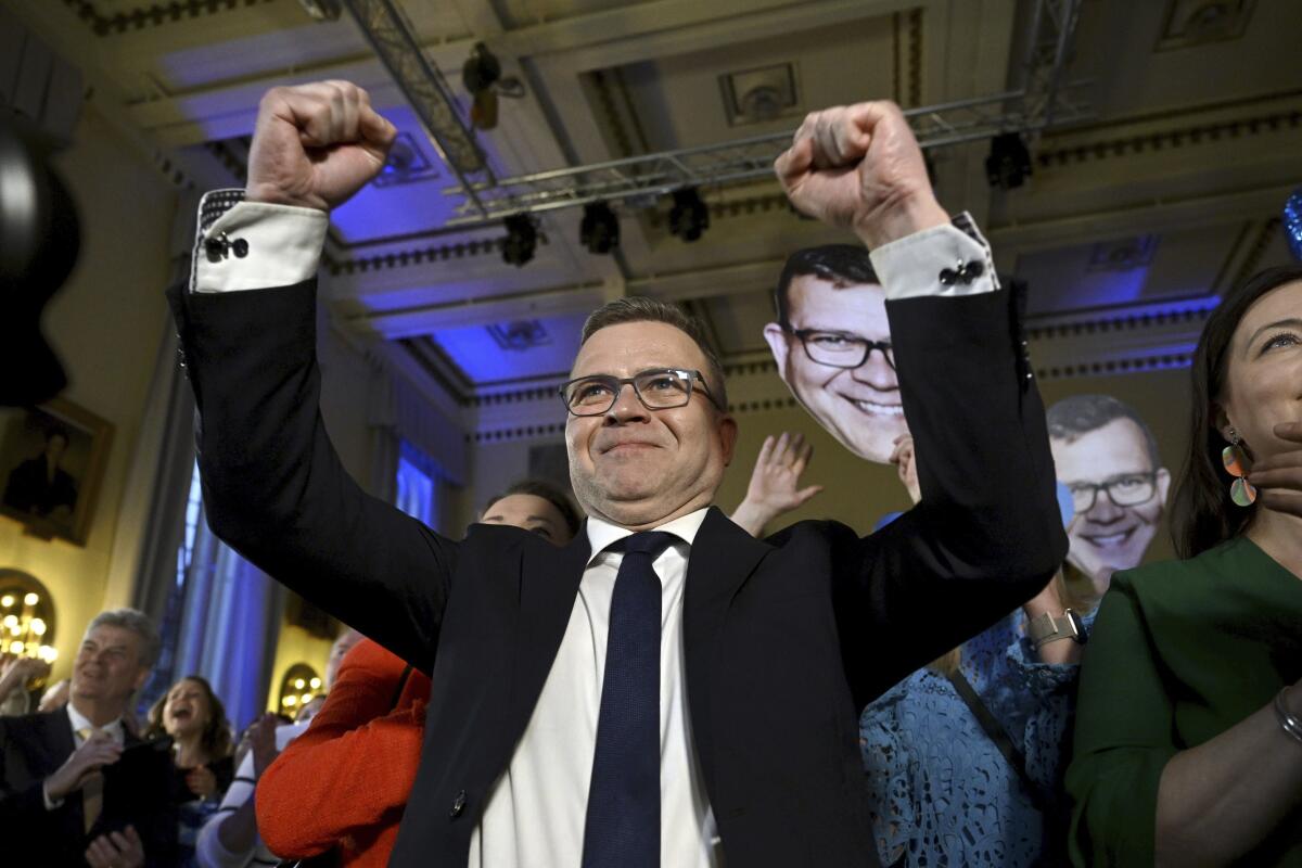 National Coalition Chairman Petteri Orpo raises his arms in celebration. 