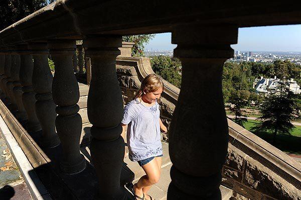 Phoebe Sasso, 8, walks down a flight of stairs during an outing with her family at the Greystone Mansion in Beverly Hills. The Greystone Mansion is among older structures that could be landmarked under new City Council rules on preservation.