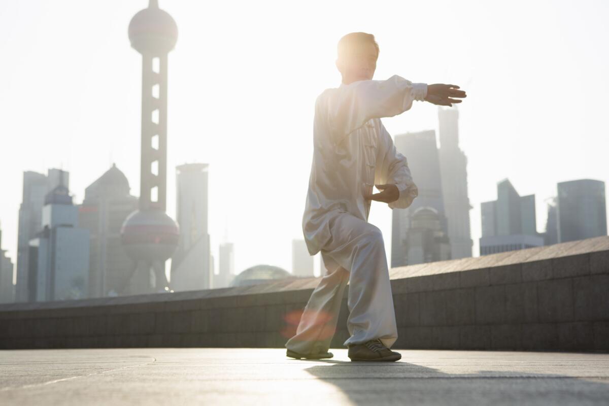 Chinese man practicing Tai Chi in the morning.