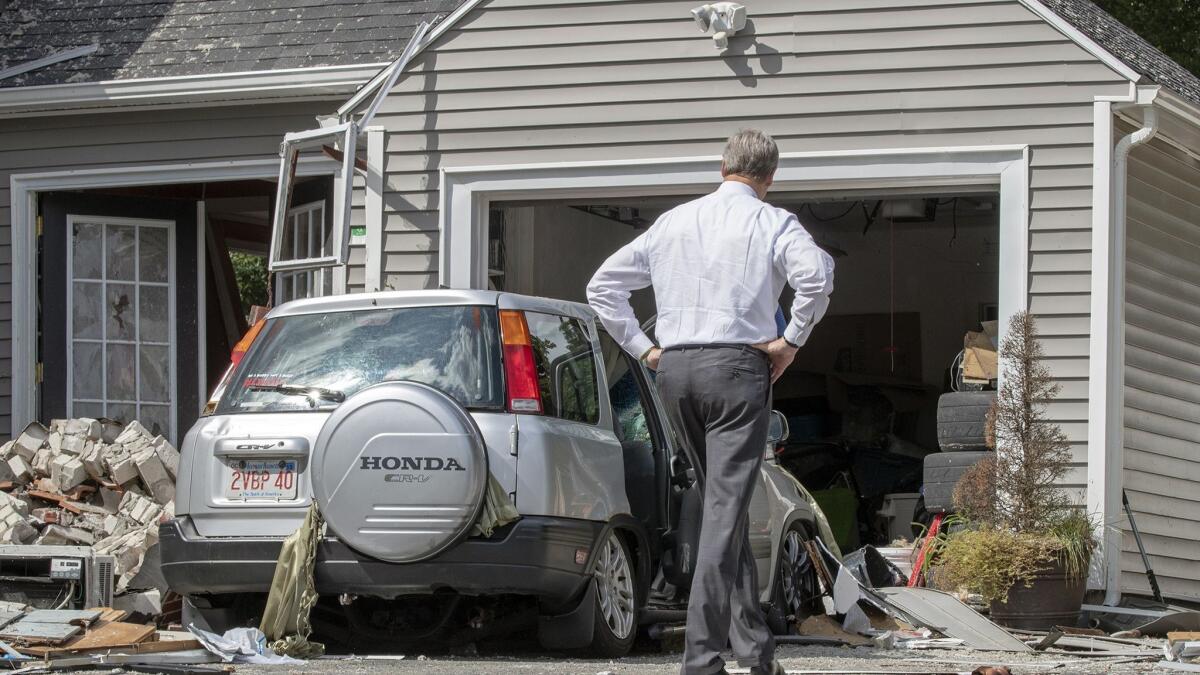 Massachusetts Gov. Charlie Baker tours the house on Chickering Road in Lawrence, where Leonel Rondon was killed Thursday in a gas explosion.