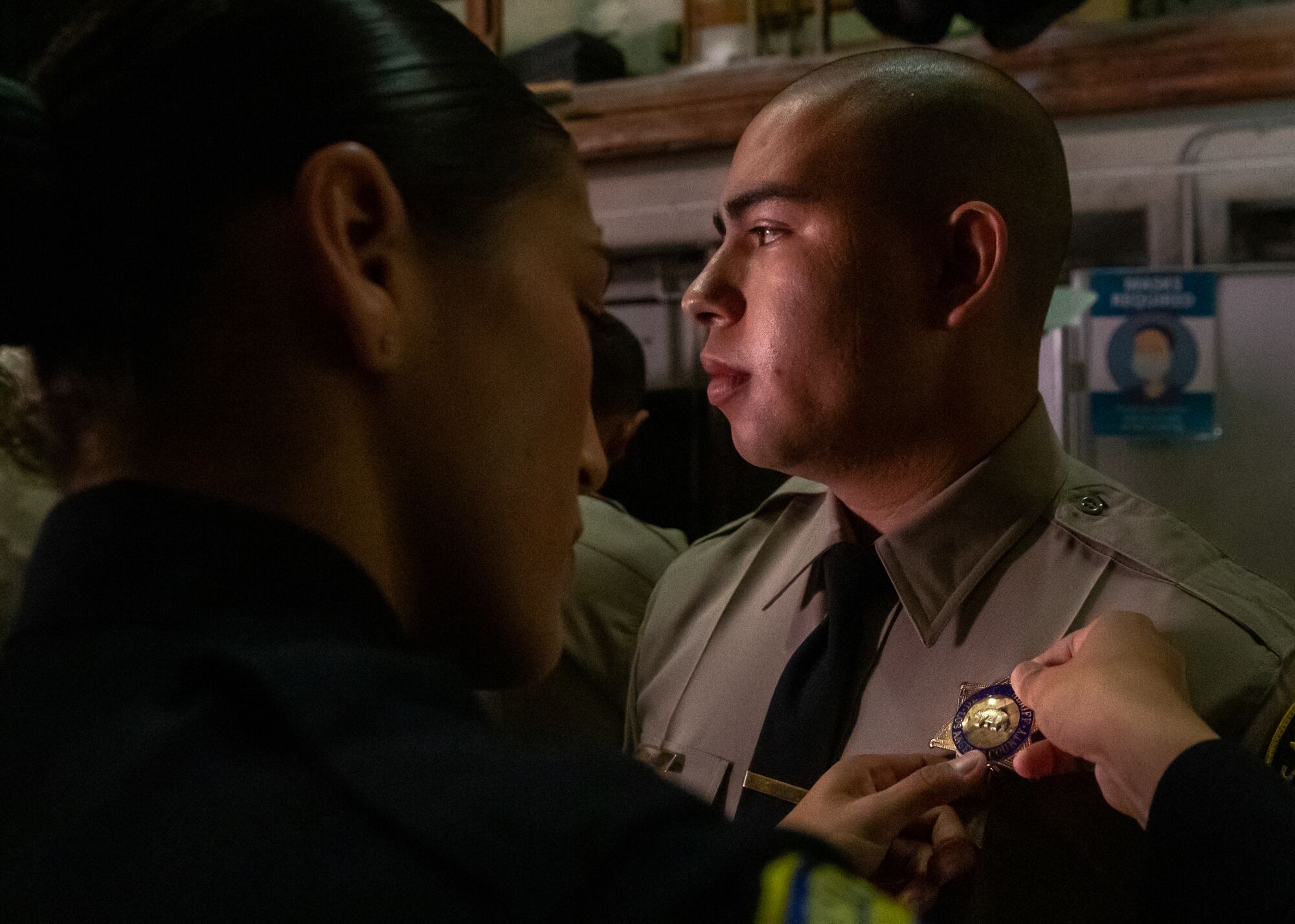 Melody Serna-Mendoza puts badge on Oscar Mora