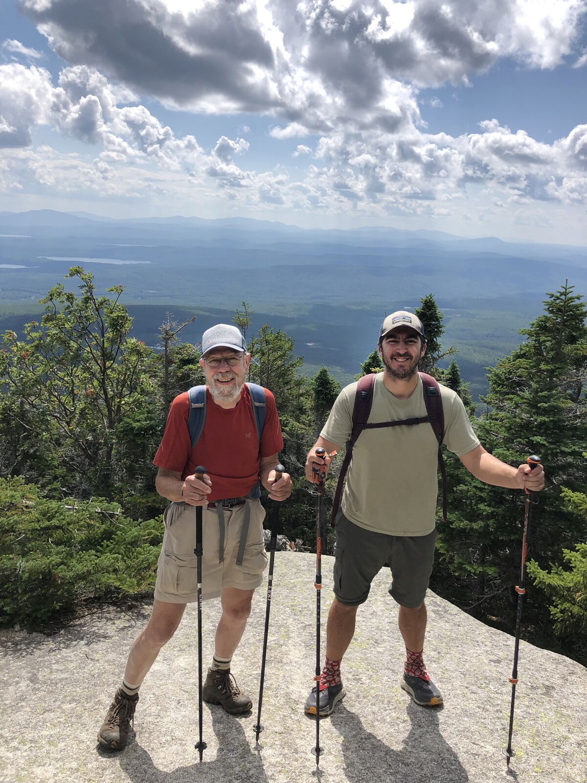 Two men in hiking gear on a mountain
