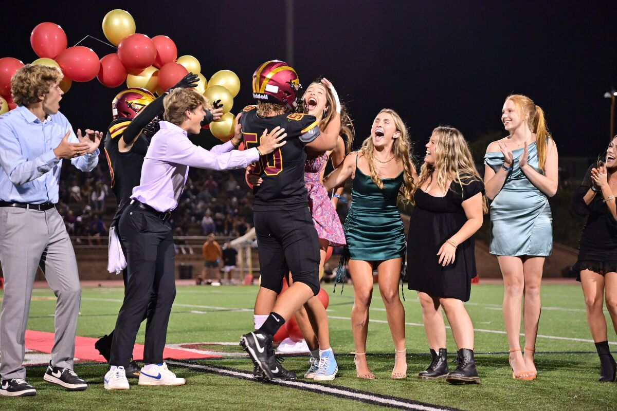 The homecoming court reacts to the announcement of king and queen.