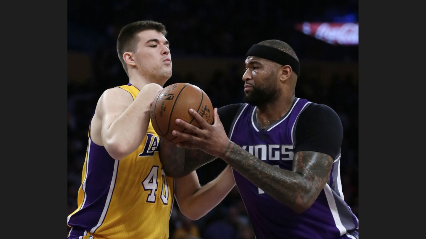 Lakers center Ivica Zubac struggles with Kings center DeMarcus Cousins during the first half of a game on Feb. 14 at Staples Center.