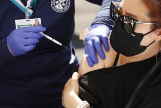 LOS ANGELES, CA - APRIL 20: Christine Im, 38, receives the Pfizer Covid-19 vaccination from student registered nurse Norliza Bayona as at a new, walk-up mobile COVID-19 clinic launched today to provide the Pfizer COVID-19 vaccine to underserved communities in Los Angeles. The walk-up clinic was presented by Councilmember Mark Ridley-Thomas in partnership with CHA Hollywood Presbyterian Medical Center (CHA HPMC) and the Southern California Eye Institute (SCEI). The Mobile Vaccine Clinic at 1819 S. Western Avenue will be open every Tuesday starting April 20 through May 25 providing free vaccines to community members who are eligible per LA County Department of Public Health (LAC DPH) vaccine distribution guidelines as they partnered with Charles R. Drew University of Medicine and Science to provide student volunteers for on-site registration allowing for walk-up appointments for community members and further ensuring vaccine access in our hardest-hit communities. Los Angeles on Tuesday, April 20, 2021 in Los Angeles, CA. (Al Seib / Los Angeles Times).