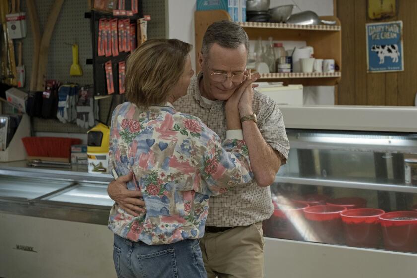 An elderly couple slow dances in a liquor store: Annette Bening and Bryan Cranston in "Jerry and Marge Go Large."