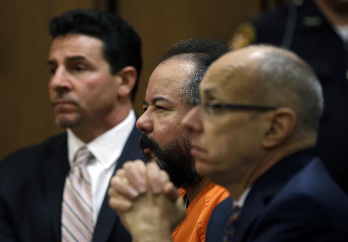 Ariel Castro, center, looks up during court proceedings on Wednesday in Cleveland. Flanking him are defense attorney Craig Weintraub, left, and Jaye Schlachet.