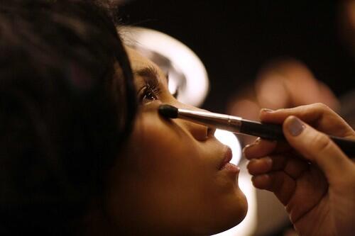 A model has her makeup done backstage before the Baby Phat fall 2009 collection show during Fashion Week