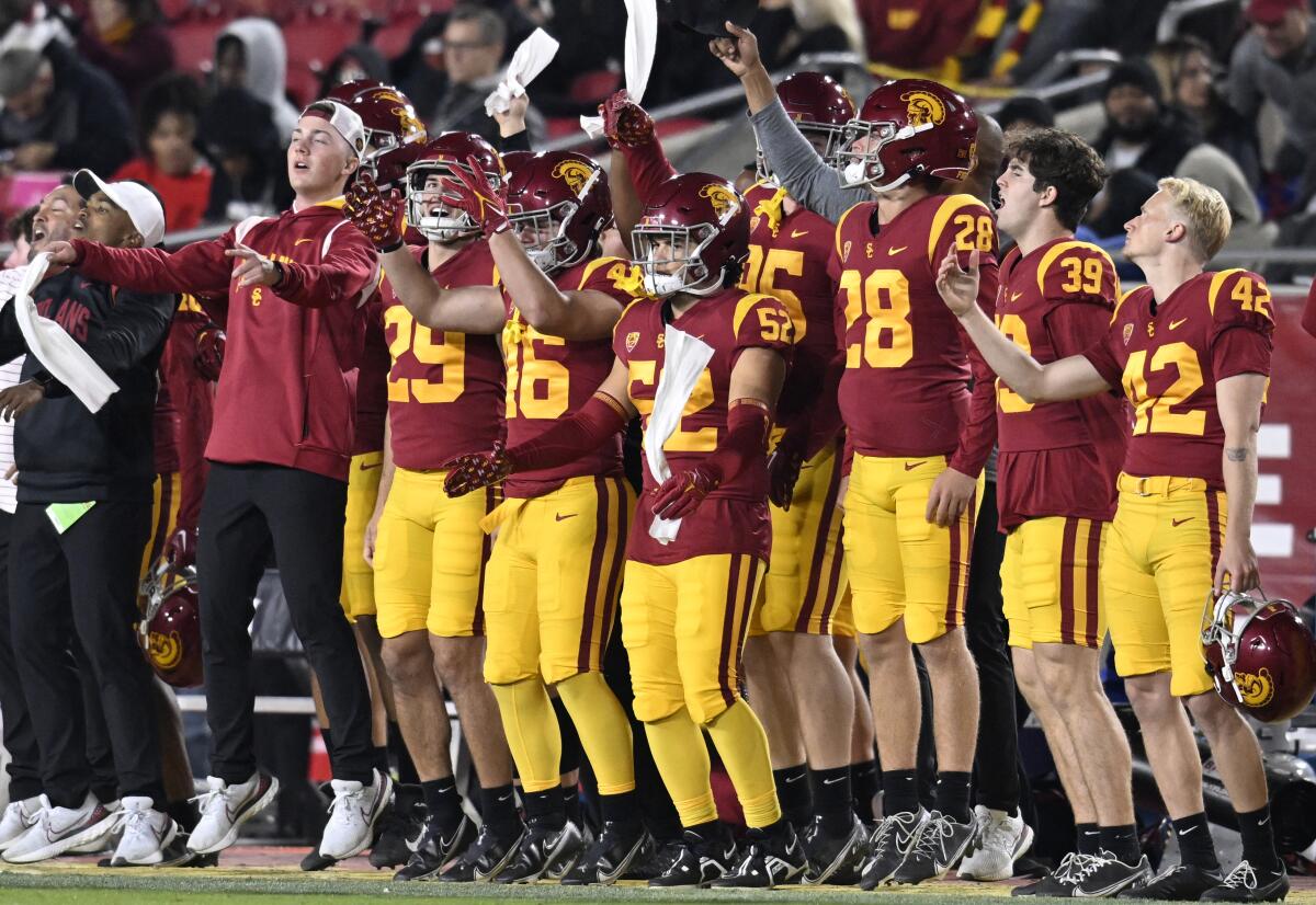 USC players celebrate on the sideline while playing California.
