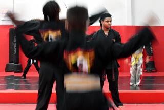 Carson, California February 3, 2023-Gregory Woodson, 17, instructs a karate class at Power of One Martial Arts in Carson. (Wally Skalij/Los Angeles Times)