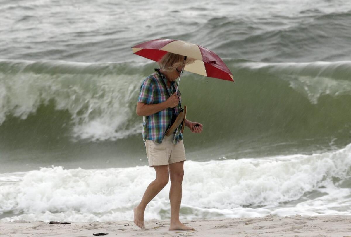 A beach in Gulf Shores, Ala. Tropical Storm Karen dissipated Sunday morning in the Gulf of Mexico, and storm preparations in the region were called off or scaled back.