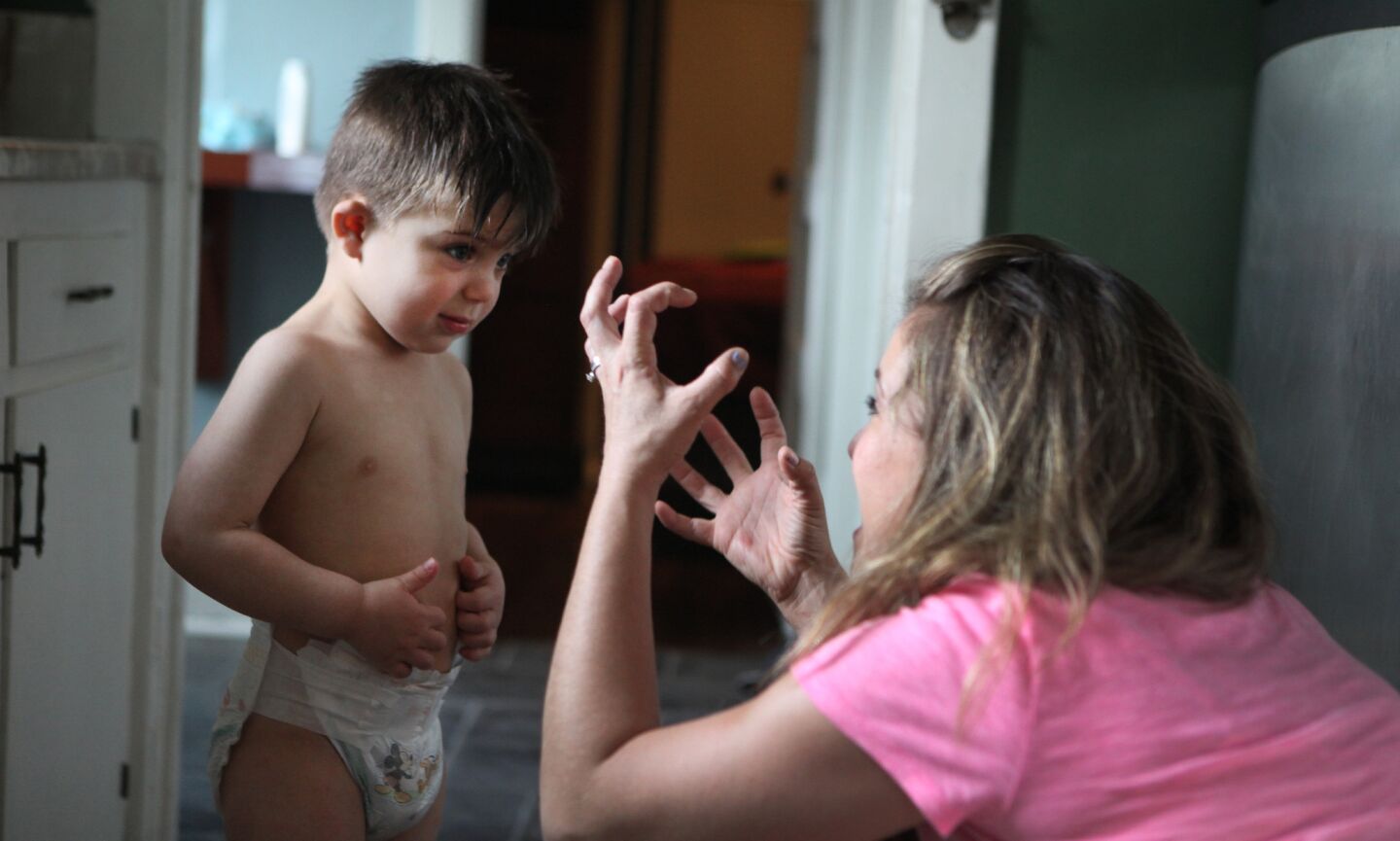 Sophie Gareau uses sign language to communicate with son Auguste, 3. The family moved to California from Canada in preparation for Auguste's brainstem implant.