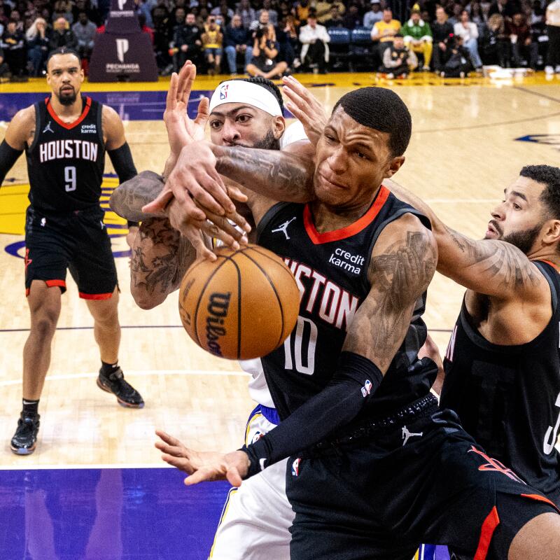 Lakers forward Anthony Davis battles Houston Rockets forward Jabari Smith Jr. for a rebound in the first half.