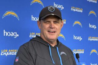 Chargers interim coach Giff Smith talks to the media after practice on Tuesday in Costa Mesa