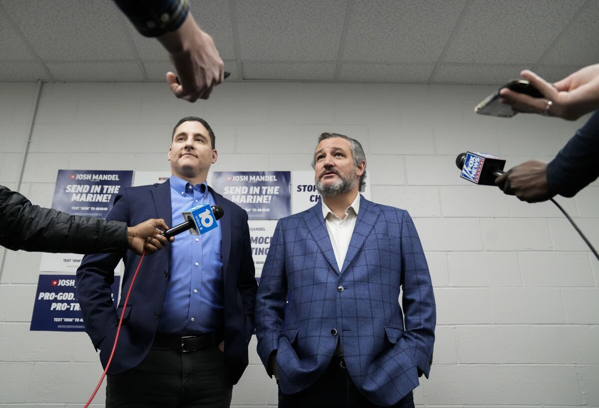 FILE - Republican U.S. Senate candidate Josh Mandel, left, and Sen. Ted Cruz, R-Texas, meet with members of the media before a campaign event at High Street Baptist Church, in Columbus, Ohio, April 30, 2022. High-profile surrogates for Republicans running in Ohio’s hotly contested Senate primary are fanning out across the state or holding other events to give their endorsed candidates a last-minute boost ahead of Tuesday’s election. Sens. Josh Hawley, Ted Cruz and Rand Paul, along with Reps. Matt Gaetz and Marjorie Taylor Greene, were among the conservative emissaries making final pitches in the critical Senate race. (Joshua A. Bickel/The Columbus Dispatch via AP, File )