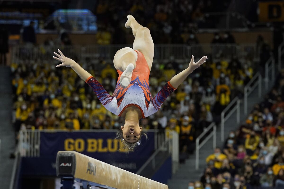 FILE -Auburn gymnast Sunisa Lee performs during a meet at the University of Michigan, Saturday, March 12, 2022, in Ann Arbor, Mich. Lee is one of the leading contenders for the NCAA women’s all-around championship, which will be decided on Thursday in Fort Worth Texas. (AP Photo/Carlos Osorio, File)