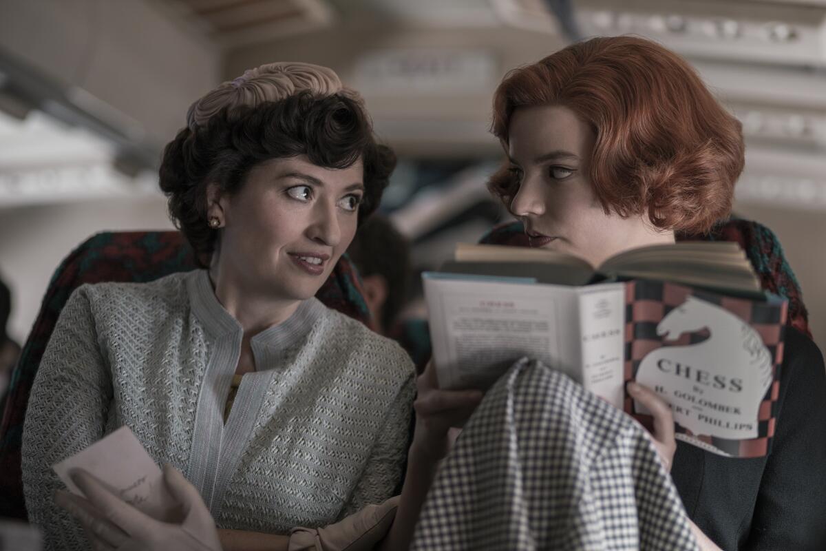 Marielle Heller and Anya Taylor-Joy on an airplane in "The Queen's Gambit."