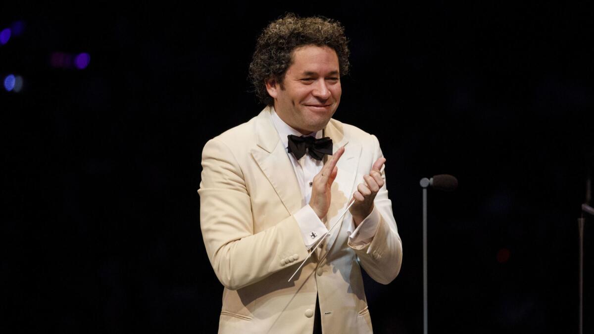 Conductor Gustavo Dudamel applauds during the L.A. Philharmonic 100th anniversary concert.