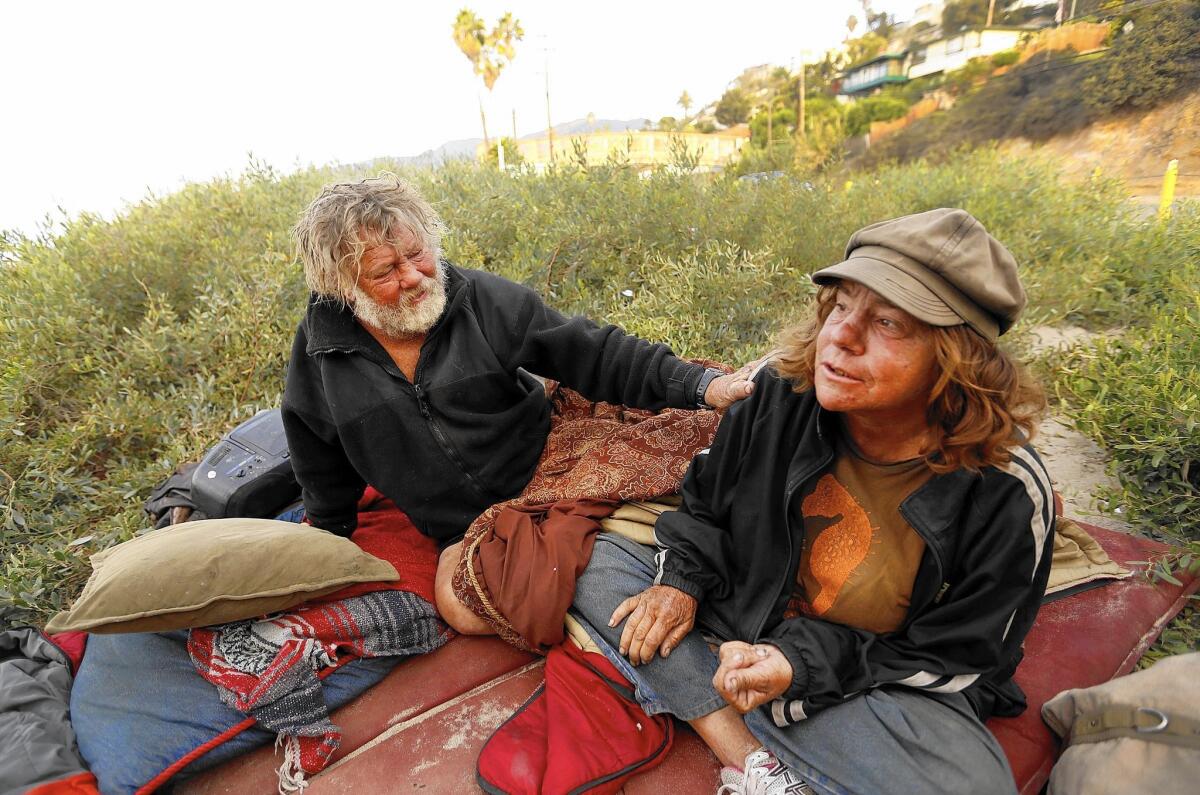 Jesse Littlefield, 57, left, and Jill Kline, 56, live at Will Rogers State Beach in Pacific Palisades. Residents have launched a private campaign to bring mental health and other services to the community’s homeless.