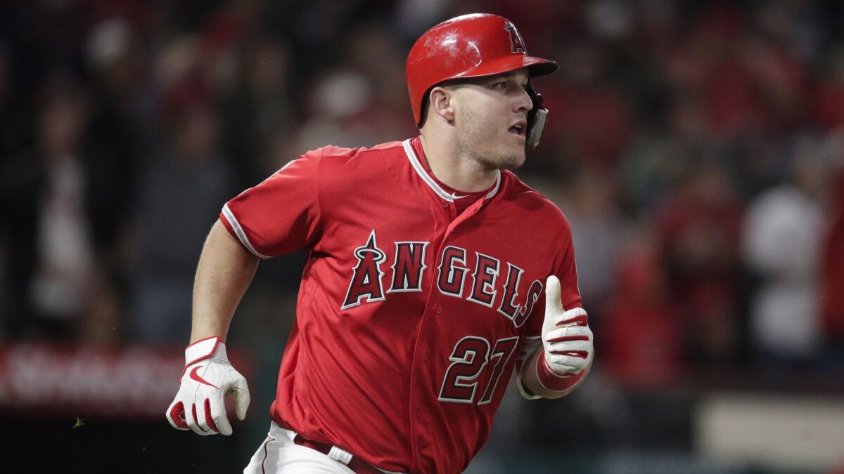 Angels' Mike Trout rounds the bases after hitting a sixth-inning home run against the Texas Rangers.