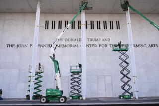 Workers adding Donald Trump's name to the John F. Kennedy Memorial Center for the Performing Arts