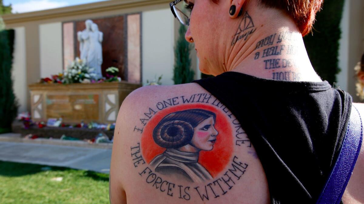 Katie Walker, 35, of Joshua Tree, has a Princess Leia tattoo on her back. She was one of many visitors to the gravesite of Debbie Reynolds and Carrie Fisher after the March 25 memorial for the mother and daughter at Forest Lawn Memorial Park in Hollywood Hills. (Francine Orr / Los Angeles Times)