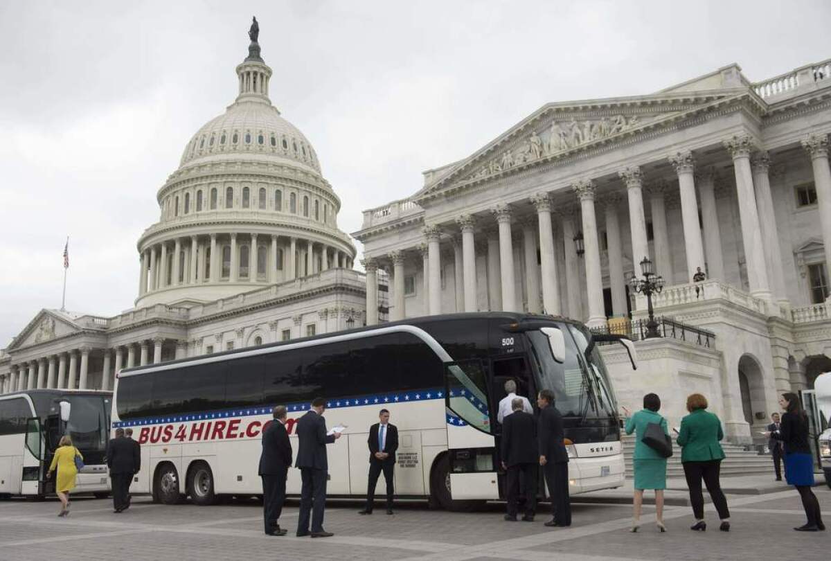 Senators board buses at the U.S. Capitol on Wednesday.