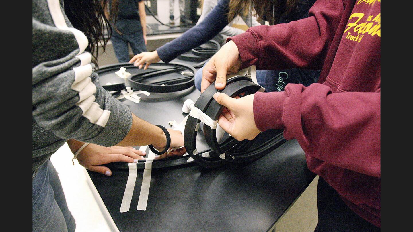 Photo Gallery: 8th grade Theodore Roosevelt Middle School students make roller coasters in physical science class