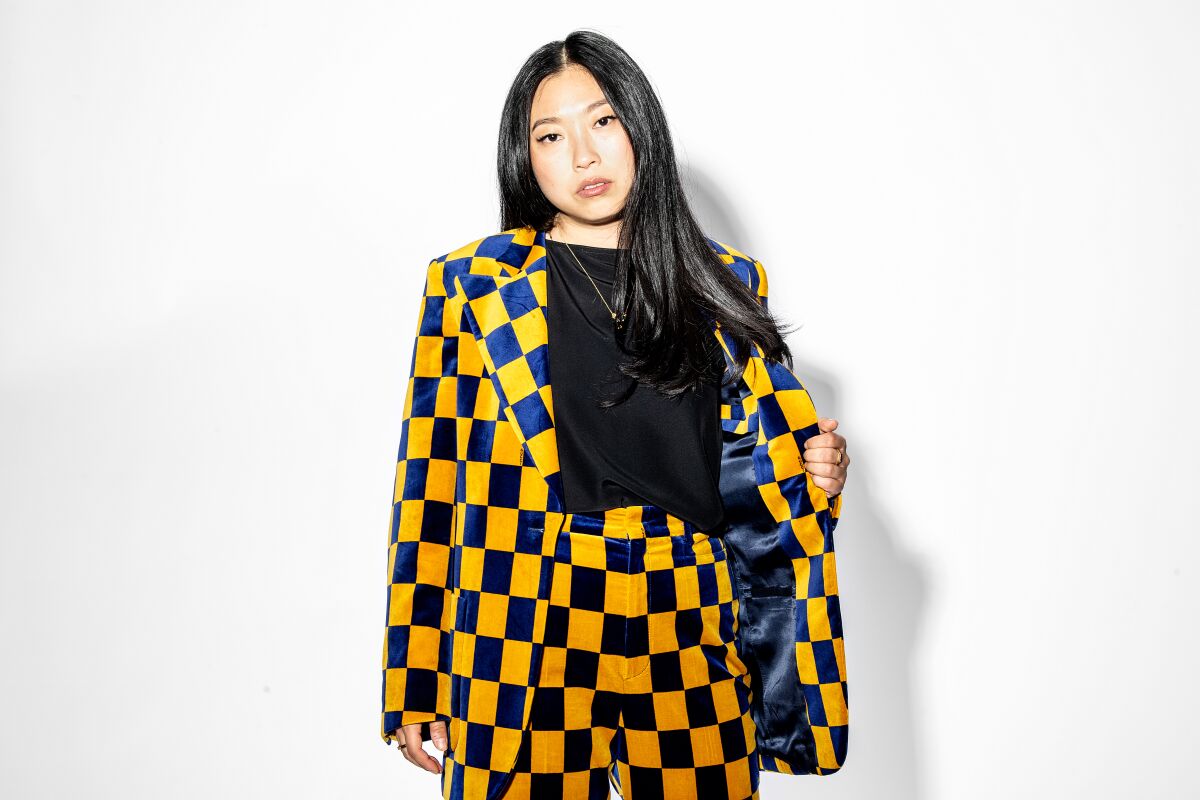 Awkwafina posing in a checkered blazer