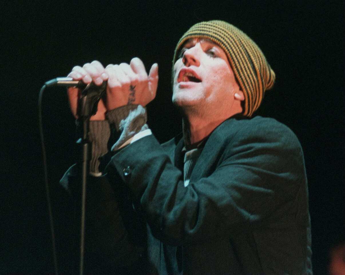 Michael Stipe sings during a R.E.M. performance in Mountain View, Calif., in 1995.